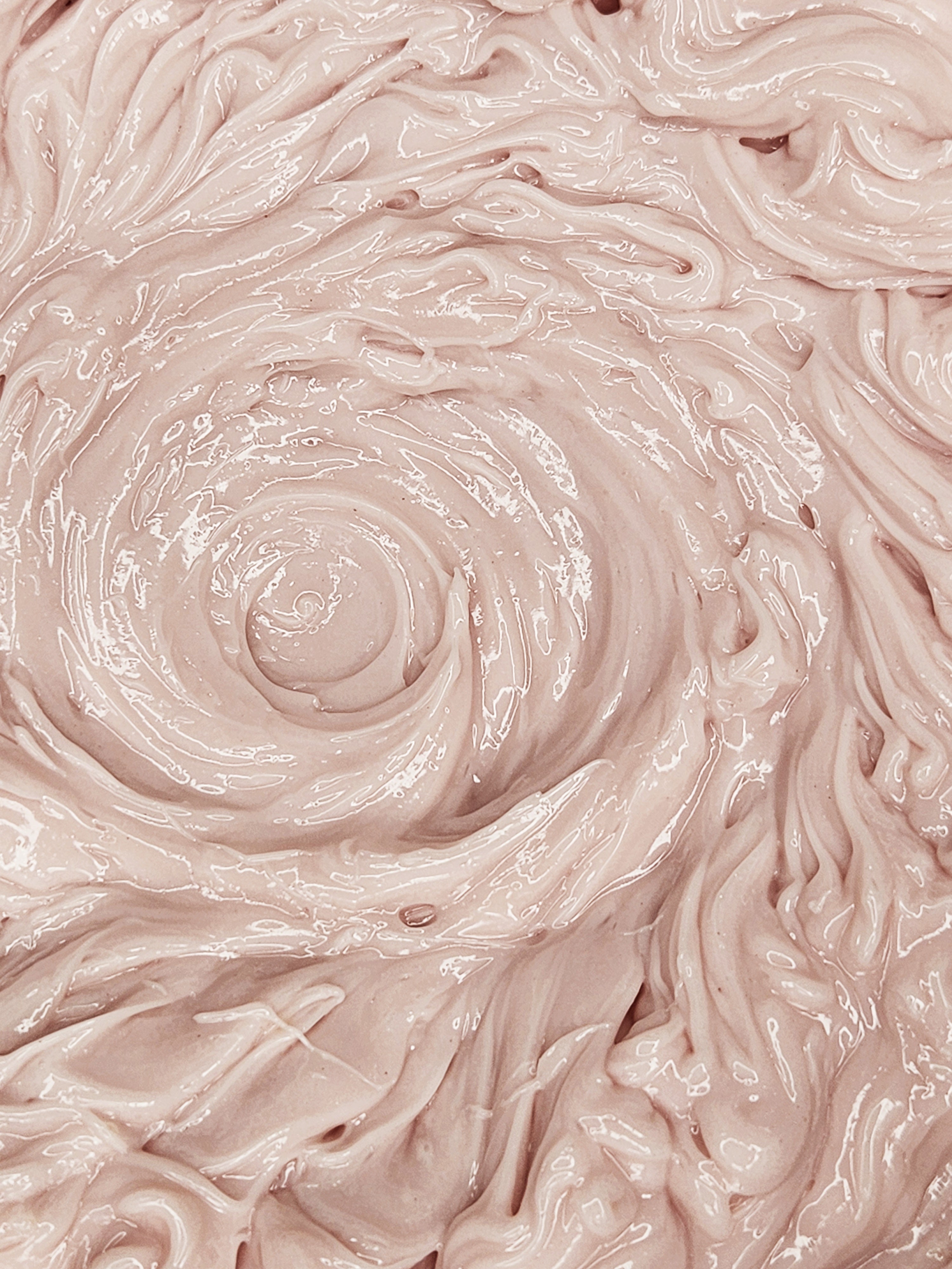 Close-up of pinkish-beige cream with a swirling pattern